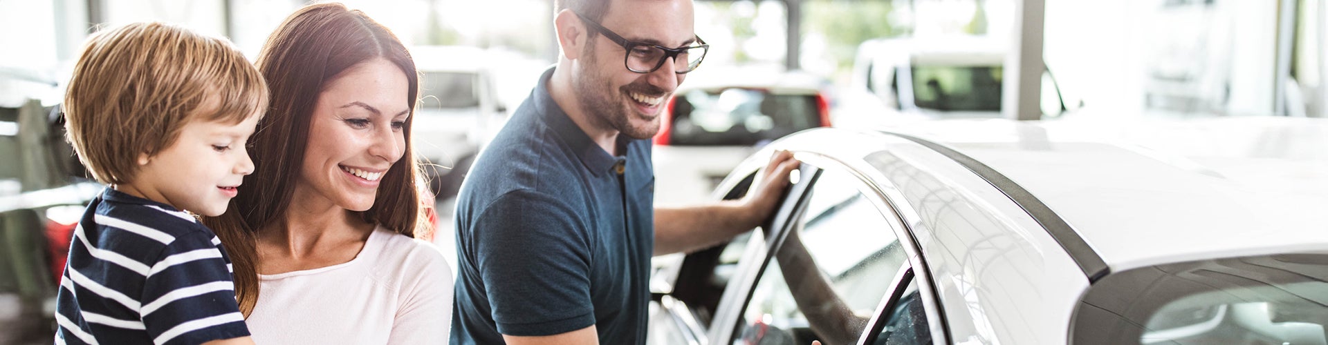 Family looking at a new car