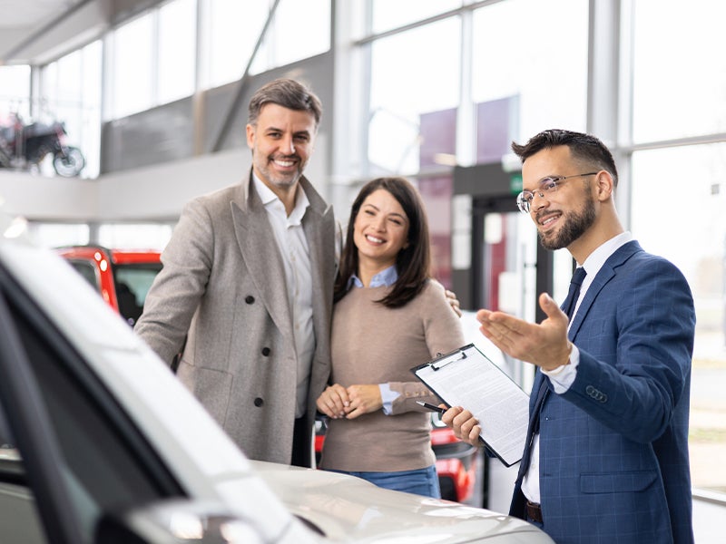 Avalon Honda Salesperson showing a family a new honda