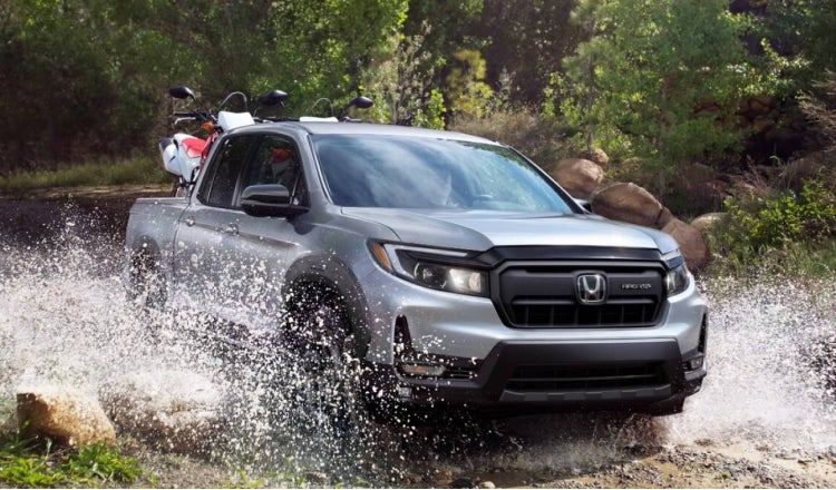 Honda Truck driving thru a stream