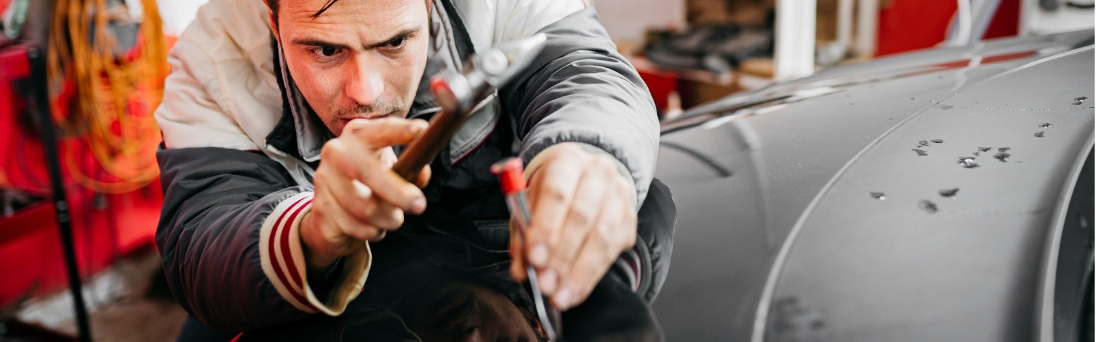 Avalon Honda Technician in the process of paintless dent repair